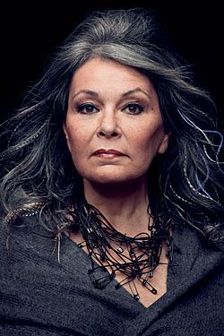 Roseanne rocks this photo. The gray hair, the makeup, the great FACE, and the amazing safety pin necklace. Roseanne Barr, Feather Extensions, Advanced Style, Going Gray, Ageless Beauty, Baby Boomer, Aging Beautifully, Feathered Hairstyles, Aging Gracefully