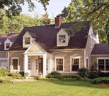 Pediment and Dormers  A portico flanked by columns and topped with a pediment adds visual interest to this home's facade. The angles of the pediment repeat those of the dormers.