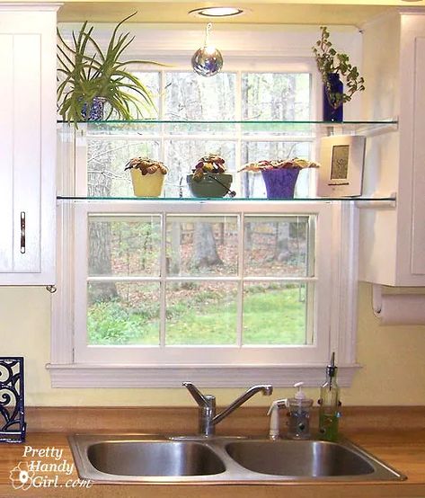 Adding glass shelves between two sets of cabinets in front of the kitchen window is an ideal location for some plants. A little quarter round moulding, finish nails and pre-cut tempered glass is all you'll need! Shelves In Front Of Kitchen Window, Shelf Over Sink, Kitchen Window Shelf, Kitchen Window Shelves, Window Over Sink, Kitchen Sink Window, Glass Shelves Kitchen, Kitchen Window Sill, Window Shelves