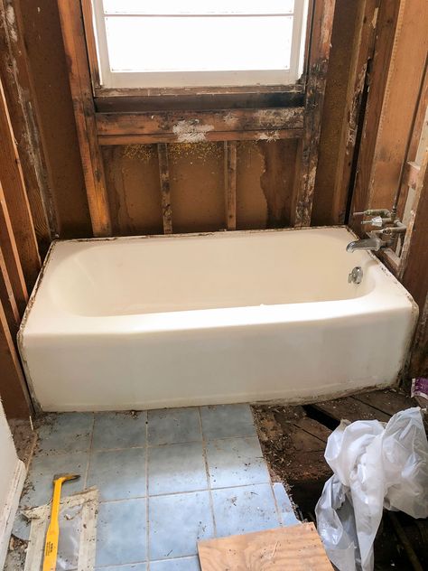 white cast iron tub in gutted bathroom Bathroom Tub Tile Surround, Cast Iron Tub Bathroom Ideas, Bathroom With Cast Iron Tub, Refinished Cast Iron Tub, Bathroom Remodel Keeping Old Tub, Bathfitters Bathtubs, Cast Iron Tub Shower Combo, Cast Iron Bathtub Ideas, Tub Remodel Diy