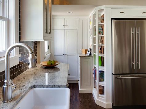 This smart kitchen design makes the most of a small space with a pantry concealed by tall white cabinets and shelves for cookbooks. Pullman Kitchen, Kitchen Ideas Layout, Small Kitchen Makeovers, White Cottage Kitchen, Kitchen With Open Shelving, Tall Kitchen Cabinets, Tiny Kitchen Design, Galley Kitchen Design, Small Kitchen Cabinets