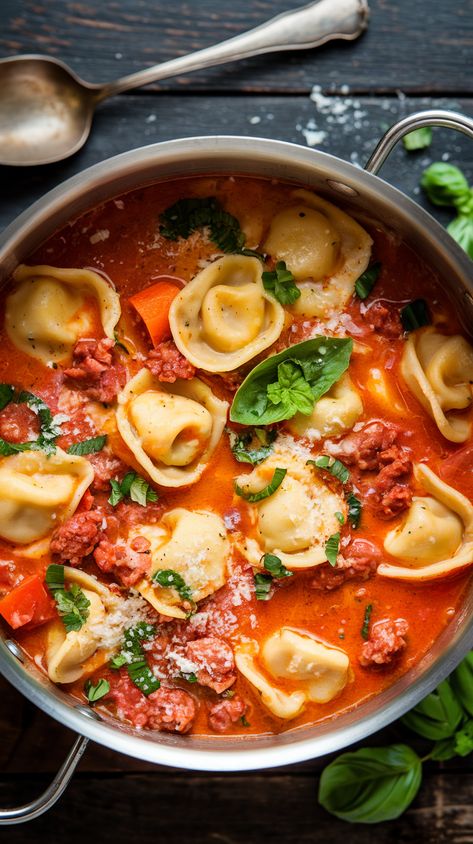 Overhead shot of creamy tortellini soup with Italian sausage, fresh vegetables, basil, and Parmesan on a dark wood surface Three Cheese Tortellini Soup, Chili Colorado Recipe, Creamy Sausage Tortellini Soup, Creamy Sausage Tortellini, Steak Stirfry Recipes, Cheese Tortellini Soup, Easy Gravy Recipe, Apple Dumpling Recipe, Sausage Tortellini Soup