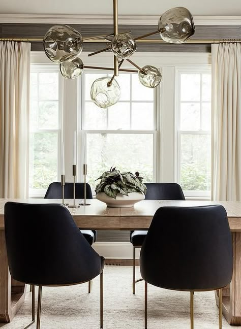 Light brown oak dining table with black leather chairs brings a modern finish under a smoke gray hand blow glass chandelier in a transitional design space. Contemporary Dining Room Design, Black Leather Dining Chairs, Black Leather Chair, Brown Dining Table, Transitional Dining Room, Transitional Dining, Dining Room Contemporary, Plastic Dining Chairs, Leather Dining Room Chairs