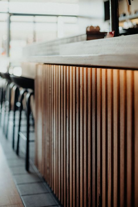 Bar With Wood Paneling, Wood Slat Bar, Bar Front Design, Paneled Bar, Beauty Clinic Design, Fluted Bar, Resturant Design, Wood Cafe, Hospitality Interior Design