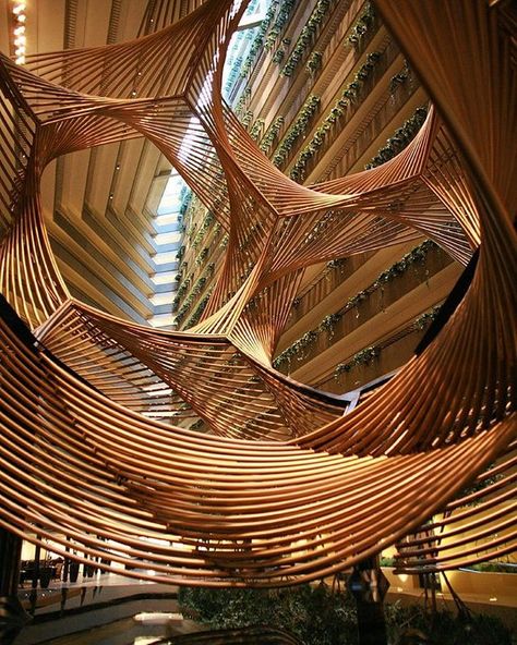 a monumental sculpture by american artist charles o. perry is suspended inside the hyatt regency in san francisco. 'eclipse' is a mathematically inspired, undulating, anodized aluminum form that spirals through the hotel's central atrium. photo by bill holmes  see more #artinstallations on #designboom #charlesperry Parametric Architecture, Parametric Design, Organic Architecture, Unique Architecture, Zaha Hadid, Futuristic Architecture, Beautiful Architecture, Amazing Architecture, Architecture Building