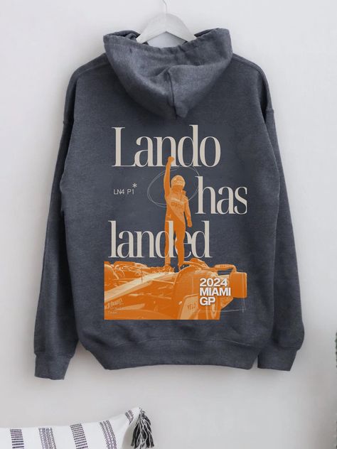 Celebrate Lando Norris's incredible P1 win at the Miami GP with the "Lando Has Landed" Hoodie. Perfect for any Formula One fan, this hoodie is all about showing your support for Lando and McLaren in style. Crafted for comfort and durability, it's ideal for race days, casual outings, or just relaxing at home. Made from ethically sourced US cotton and polyester, and dyed with eco-friendly colours, this hoodie is both stylish and sustainable. Whether you're a die-hard F1 fan or just love motorsport Lando Norris Hoodie, Formula One Merch, Mclaren Hoodie, Mclaren Outfit, Mclaren Merch, F1 Clothing, F1 Hoodie, Miami Gp, F1 Merch