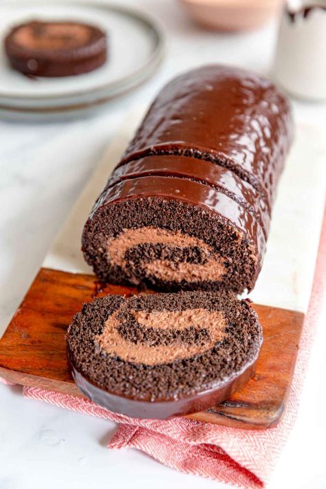 This Double Chocolate Swiss Roll recipe is made for chocolate lovers. It's the perfect weekend or holiday cake that both kids and adults adore. For the decoration we simply coated it in chocolate, however, feel free to sprinkle with chocolate shavings too. #jernejkitchen #doublechocolate #chocolateswissroll #swissrollcake #dessert Chocolate Swiss Roll Recipe, Chocolate Swiss Roll, Chocolate Roll Cake, Swiss Roll Cake, Cake Roll Recipes, Holiday Cake, Chocolate Roll, Yule Log, Swiss Roll