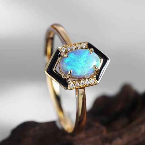 Lately, I've been smitten with black agate in my designs. This side stone adds a unique flair, bringing a completely different vibe that pairs perfectly with opals. Here's the latest design—I hope you love it as much as I do! #18KGold #LuxuryFashion #OpalLove #Opal #engagementring #JewelryLove #OpalMagic #FineJewelry #OpalJewelry #JewelryMagic #JewelryArt #opalring #JewelryLovers #FineJewels #DesignJourney #Gold #EngagementRing #Ring #UniqueDesign #DiamondRing #BlackOpal #blackopal #Diamond... Black Opal Engagement Ring, Opal Promise Ring, Australian Black Opal, Beautiful Gemstones, Promise Rings For Couples, Cubic Zirconia Engagement Rings, Agate Engagement Ring, Opal Engagement, Synthetic Opal