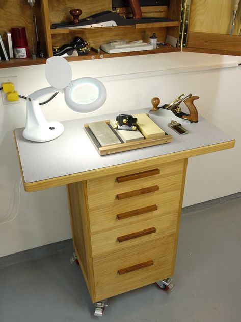 I built this cabinet for use as a sharpening station. It sits directly below my tool cabinet and has plenty of storage for sharpening gadgets.  It's constructed of pine and 1/2" birch plywood. The drawers are inset style and dovetailed. The wide top is covered with plastic laminate.  Casters are 3" double locking from Woodcraft. Finished with Tried & True Varnish Oil.  Completed August 2006. Sharpening Station, Tool Cart, Workshop Ideas, Small Workshop, Tool Cabinet, Tool Shop, Wood Tools, Woodworking Bench, Woodworking Ideas