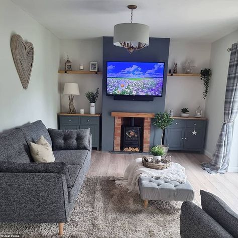 The Powney's removed the dark grey wallpaper and wooden floor in favour of brighter tones and added a stunning log burner fireplace to make the room as cosy as possible. Pictured, after the transformation Terrace House Living Room, Zinc Sofa, Log Burner Living Room, Dark Grey Wallpaper, The French Connection, Small Lounge, Sofa Style, Living Room Renovation, Living Room Styles