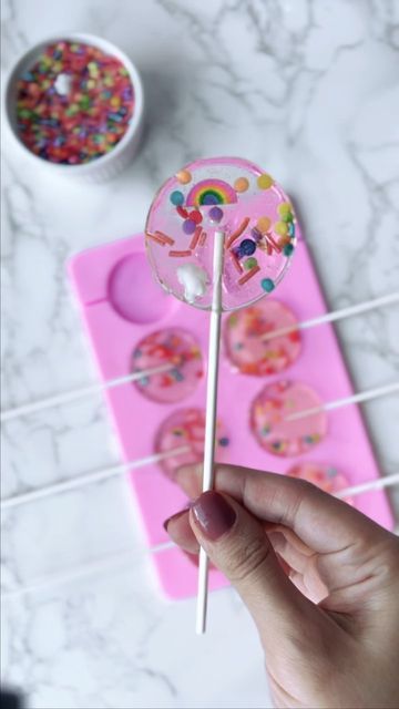 Rita Tohmé-Kikano on Instagram: "🍭 How to: Making Lollipops🍭 These next few weeks I will share with you my tricks and treats *See what I did here* for easy celebration ideas! Ingredients for the lollipops: Canola Oil 1 cup sugar 1/2 cup light corn syrup 1/4 cup water 1 1/2 teaspoons extract (I used Raspberry extract) Full Recipe in Comments" Making Lollipops, Homemade Lollipops, Raspberry Extract, Celebration Ideas, Christmas School, Candy Making, Canola Oil, Girl Cakes, Corn Syrup