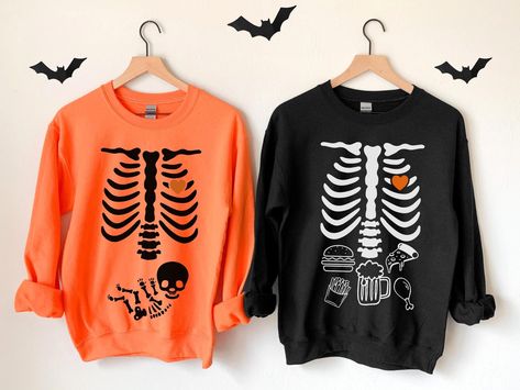 Funny Matching Couples Gift for New Mom and Dad, Halloween Pregnancy Crewneck Sweater, Gender Reveal Baby Skeleton Maternity Clothes, Cute Gift for New Expecting Parents, Little Pumpkin, Goth Baby Shower Themed Party Shirt, Mommy to Be Thanksgiving 2022 Pregnancy Announcement T-Shirt, Spooky Season Baby Coming Soon, Gender Reveal Party Costume These well-loved Halloween pregnancy sweatshirts are perfect for your favorite fall, autumn, Halloween, or Christmas nights!  ✧ SIZING ✧ ⋒ Please check ou Halloween Costume Ideas For Pregnant Mom, Pregnancy Halloween Announcement, Pregnancy Announcement Costume Halloween, Pregnant Couple Costumes Halloween, Halloween Costume Pregnancy Announcement, Halloween Costumes For Pregnant Couples, Pregnancy Announcement Halloween Costume, Diy Pregnant Halloween Costumes, Halloween Costumes For Pregnant Women