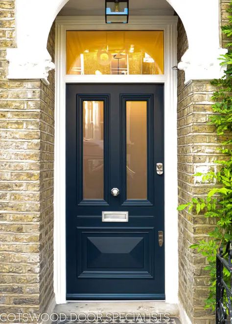 A beaded Victorian door in a stately shade of dark blue. The door features two long glass panels and a stunning raised cricket bat panel with moulded surrounds. The midrail around the letterplate incorporates a special horizontal bead element, replicating the style of the original local joinery. This eye for traditional detail is what makes a Cotswood door so special. Installed in a pristine white frame in a yellow stock brick London home. Navy Front Door, Victorian Front Door, Timber Front Door, Victorian Doors, Bespoke Joinery, Victorian Front Doors, Front Door Inspiration, Traditional Front Doors, Blue Front Door