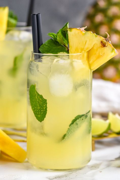 This Pineapple Mojito is the perfect piña colada twist on one of our favorite cocktails. A few extra simple ingredients kicks this mojito up a notch and will make it your favorite too! Pineapple Mojito Recipe, Pineapple Coconut Mocktail, Pineapple Mojito Recipe Pitcher, Pineapple Mango Mojito Recipe, Coconut Mojito Mocktail, Tito’s Pineapple Coconut Mojito, Pineapple Mojito, Flavored Rum, Vodka Soda