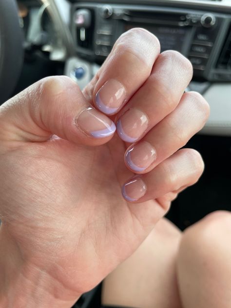 A photo shows a left hand with all fingernails visible. The nails are nude on the nail bed with a lavender French tip Dip Nails Lavender, Lavender French Tip Nails Short, Short Nail French Manicure, Short Nail French, French Tip Gel Manicure, Nude Dip Nails, Lavender French Tips, Lavender French Tip, Nail French Manicure