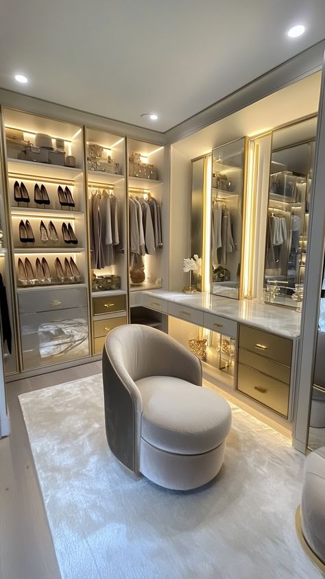 Step into Leo's luxe sanctuary ✨ His walk-in closet dazzles with an illuminated shoe display 👠, full-length mirrors for the perfect outfit check 🪞, and a glamorous vanity for getting ready. Plush seating offers comfort, while gold hardware adds the finishing touch of opulence 💫👗💎. Walk In Closet Glam Room, Woman Walk In Closet Luxury, Luxury Walk In Closet With Vanity, Dream Walking Closet, Luxury Walk In Closet Aesthetic, Walk In Closet With Makeup Vanity, Vanity Closet Room, Walk In Closet With Mirror, Big Closet Ideas