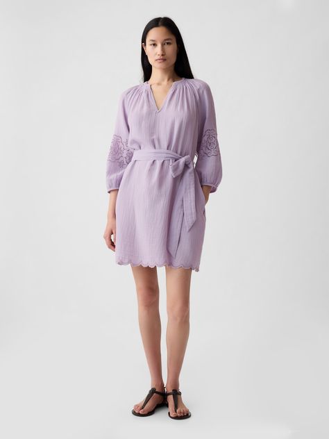 Soft cotton crinkle gauze mini dress.  V-neck.  Elbow sleeves with floral embroidery.  Tie belt at waist.  Scalloped hem.  * Fit: Relaxed.  An A-line silhouette that's easy through the chest with a flared opening.  Hits above the knee.  Models wearing Gap 2024 Purple, Bakery Display, Crinkle Cotton, Embroidered Mini Dress, Purple Mini Dresses, Wedding Guest Dress Summer, Elbow Sleeve, Scalloped Hem, Mini Dress With Sleeves