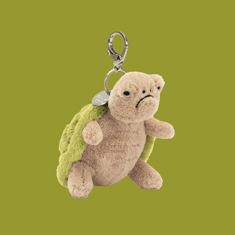 Timmy Turtle Bag Charm is the perfect companion to add a little personality to your bags on the go! His grumpy face is still the most adorable thing you've ever seen and he's sure to bring smiles to faces he comes across. Silver hook attachment included to easy add to handbags, backpacks and more! Timmy The Turtle, Jellycat Keychain, Silly Trinkets, Cute Pins For Backpacks, Purse Aesthetic, Grumpy Face, Jellycat Stuffed Animals, Turtle Keychain, Preppy Bags