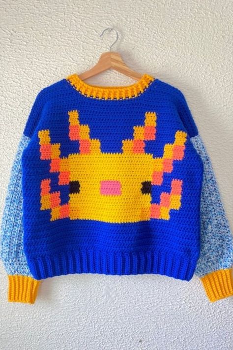 If you love the Axolotl in Minecraft, you'll enjoy making this cool Minecraft crochet sweater. This pattern will show you how to make an Axolotl themed sweater. Minecraft Crochet Patterns, Trendy Crochet Sweater, Minecraft Crochet, Axolotl Crochet, Minecraft Outfits, Beautiful Dawn, Sweater Designs, Crochet Fairy, Crochet Jumper