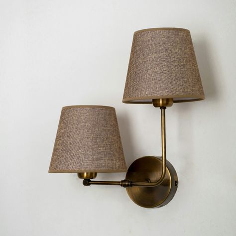 Antique Brass Wall Lamp Enhance the charm of your home with our Antique Brass Wall Lamp, a sophisticated addition to any decor style. This stunning wall lighting fixture features a vintage-inspired design with modern touches, perfect for creating a cozy and stylish ambiance. Features: The dual fabric lampshades in a warm, earthy tone provide a soft, diffused light that adds a touch of nostalgia to any room. The elegant aged brass finish offers a timeless look that complements both traditional an Coved Ceiling Lighting, Brass Can Lights, Battery Powered Wall Sconces, Vintage Sconces Bedroom, Lights Next To Tv, Vintage Style Interior Design, Gallery Wall Lighting, Wall Lights Uk, Bedside Sconces