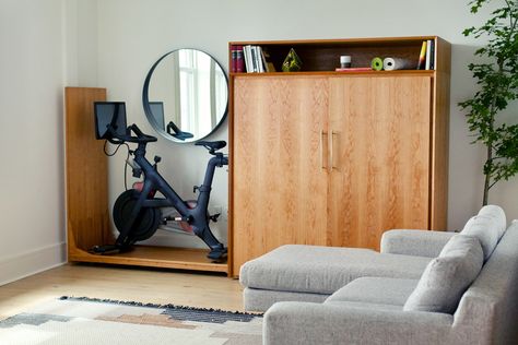 Finally a Way to Hide the Exercise Equipment in Your Living Room Hide Exercise Equipment, Bike Cabinet, Mid Century Cabinet, Workout Equipment, Exercise Bike, Exercise Equipment, Yanko Design, One Bedroom Apartment, Hand Crafted Furniture