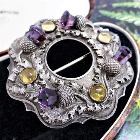 I don't use the rare word much but I believe this piece is worthy of the word. A large Georgian Scottish amethyst and citrine pin. A crisp set of Edinburgh hallmarks can be seen on the reverse including the duty mark - head of King George lll. The thistle foliage repousse detail is exquisite, and those gemstones!! 💜💛 Scottish Pipe Band, Thistle Jewellery, Celtic Jewellery, Scottish Jewelry, Arts And Crafts Era, Amethyst And Citrine, Daily Wear Jewellery, Scottish Jewellery, Diamonds Rings