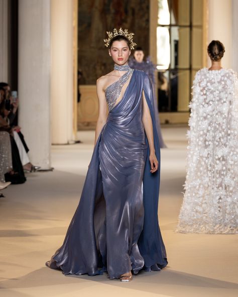 Granite blue mermaid dress in silk cloquet, with a game of draping on the skirt waving from the waist and hips. Flowy sleeves with collar attached blending into the overskirt. The movement is interrupted in the crystal and silver beading around the bodice. #TonyWardCouture #TonyWardHCFW2425 #PFW #CoutureWeek Blue Mermaid Dress, Tony Ward Couture, Fashion Show Dresses, Fancy Dresses Long, Tony Ward, Haute Couture Dresses, Formal Cocktail Dress, Fall Winter 2024, Couture Week