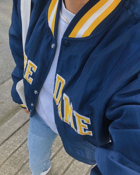 mariana on Instagram: “i am a little bit obsessed with this jacket” blue and yellow notre dame collegiate varsity jacket ootd | college and university style | denim fashion outfit #varsityjacket #notredame #ootd #outfitdetails #whatiwore #fashionblogger #outfitinspo #candid #contentcreator Blue And Yellow Varsity Jacket, College Jacket Aesthetic, Yellow Jacket Outfit, Denim Fashion Outfits, Ootd College, Varsity Jacket Style, Jacket Ootd, Senior Jackets, Varsity Jacket Outfit