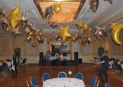 Venue decoration with mylar balloon stars and moons! A reader asks: If I want to hang foil stars from the ceiling, do I fill them with air or helium? And can I use fishing wire to attach them to the ceiling? Read my answer here: http://www.balloon-decoration-guide.com/how-to-hang-foil-balloons-from-ceiling.html Star Balloon Decorations, How To Hang Balloons From Ceiling, Hanging Stars From Ceiling, Balloons From Ceiling, Phd Party, Nye Decor, Valentines Balloons Bouquet, Sweetheart Dance, Hanging Balloons