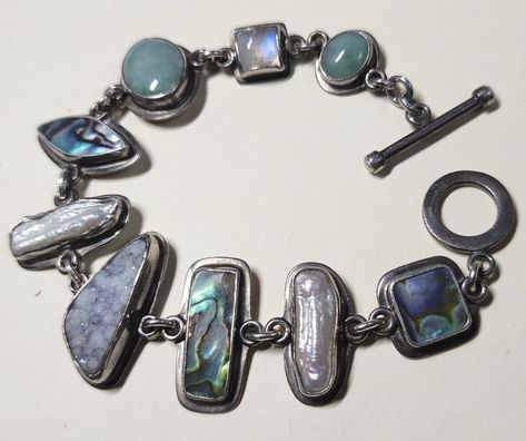 Tabra Tunoa: sterling silver "treasure" bracelet with quartz, moonstone, paua/abalone shell, druzy, and pearl (asking US $205.14 on eBay, February 2023) Abalone Shell Jewelry, Vintage Spoon Jewelry, Abalone Shell Bracelet, Taxidermy Jewelry, Silversmithing Jewelry, Silver Jewlery, Spoon Jewelry, February 2023, Dope Jewelry