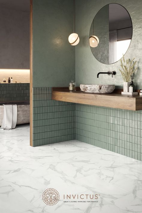 Love the scandi or Japandi style? This sage green bathroom with wooden countertop, natural stone bathtub and marble flooring offers the both of both worlds. The marble flooring look stunning and feel incredibly comfortable to walk on barefoot. Moreover, these vinyl flooring tiles are 100% waterproof and easy to maintain. Minimalism never looked cosier! #marblebathroom #minimalistbathroom #luxuryvinyltiles #flooringideas Japandi Style Interior Design, Japandi Bathroom Design, Design Interior Baie, Japandi Bathroom, Makeover Kamar Mandi, Dekorere Bad, Green Tiles, Japandi Interior, Decor Baie