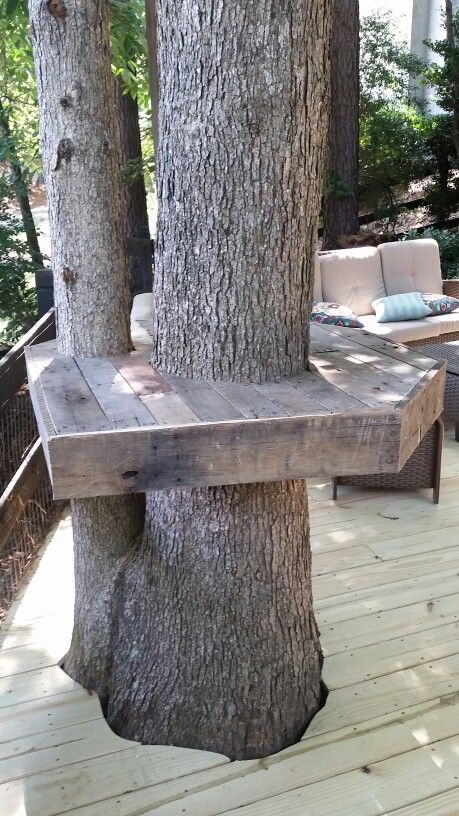 Pallet Tree Bar Using a couple of old pallets I tore down the pallets using all of the wood from the 2x4s to the slats. Connected the structure by using threaded rod and sandwiched the frame around the trunk allowing for growth of the tree. I set Bar top at 40 inches to allow for 2 30 inch outdoor stools. Deck Around Trees, Bench Around Trees, Pallet Tree, Tree Bar, Tree Deck, Popular Woodworking Projects, Tree Bench, Recycled Pallets, Garden Cafe