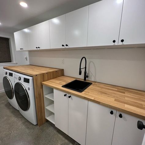 @braveelement on Instagram: "So in love with this laundry room! All @ikeausa cabinets, doors, butcher block, sink & faucet. Knobs are @lewshardware . . . #ikea #ikeahack #butcherblock #laundryroom #laundry #blackhardware #sleek #diy #hgtv #sektion #beautiful #clean" Laundry Room Countertop Organization, Butcher Block Countertop In Laundry Room, Butcher Block Countertop Laundry Room, Butcher Block Counter Laundry Room, Small Laundry Room Butcher Block Counter, Black Cabinets Butcher Block Counter Laundry Room, Butcher Block Counter Over Washer And Dryer, Laundry Room Butcher Block, Laundry With Butcher Block Counter