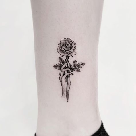 Tattoo of a hand holding a single stem rose. Black and grey, detailed, single needle / fineline, microrealism tattoo. Rose Tricep Tattoo, Long Stem Rose Tattoo, Hand Holding Rose Tattoo, Holding Rose Tattoo, Tattoo Of A Hand, Hand Holding Flower Tattoo, Scattered Tattoos, Rose Thorn Tattoo, Deep Meaningful Tattoos