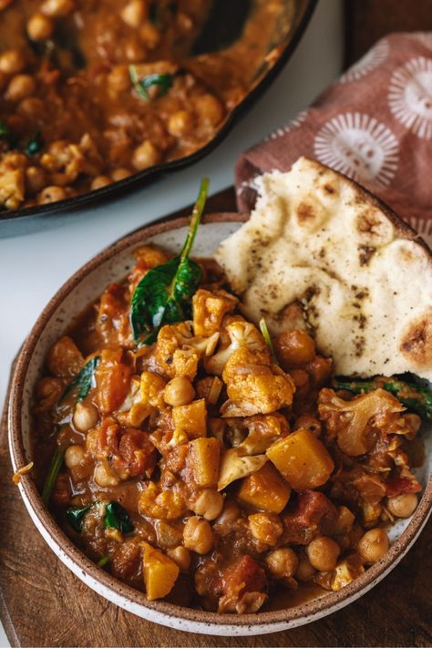 Sweet, earthy pumpkin and nutty cauliflower combine in this fragrant, soul-hugging Pumpkin Cauliflower Curry. A warm and nourishing fall stew made with coconut milk, chickpeas, and spinach. Fall Stew, Pumpkin Cauliflower, Chickpeas And Spinach, Pumpkin Stew, Pumpkin Curry, Vegetarian Curry, Cauliflower Curry, Fall Dishes, Vegan Curry