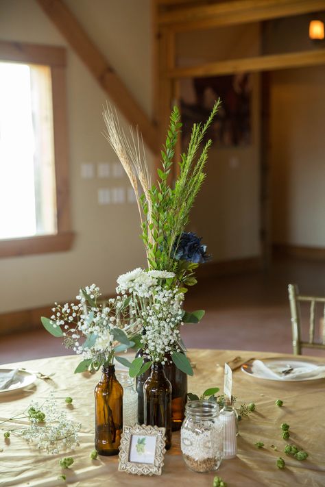 Beer Bottle Flower Vase, Beer Bottle Flower Arrangements, Beer Bottle Wedding Decor, Brewery Wedding Ideas, Beer Bottle Wedding, Beer Bottle Centerpieces, Beer Bottle Vase, Craft Beer Wedding, Wedding Shower Centerpieces