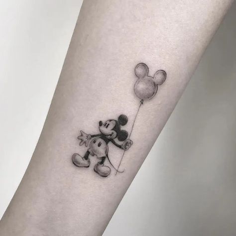 30 Best Disney Tattoo Ideas You Should Check Small Mickey Mouse Tattoo Simple, Disney Wrist Tattoo, Ny Tattoo Ideas, Disney Balloon Tattoo, Up Tattoo Disney, Hidden Disney Tattoo, Disney World Tattoo, Disney Small Tattoo Ideas, Subtle Disney Tattoos