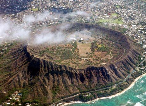 The Hawaiian Islands were formed as the Pacific Plate moved westward over a geologic hot spot. The most populous Hawaiian Island, Oahu, is dominated by two large shield volcanoes that range in age from two to four million years old. However, a fair number of smaller and much younger volcanic craters are also present on Oahu, such as Diamond Head Crater pictured above. These younger eruptions were also much smaller in lava output, and much more explosive in nature than the older shield lavas. Diamond Head Hawaii, Shield Volcano, Kauai Island, Oahu Vacation, Hawaii Trip, Oahu Wedding, Diamond Head, Study Ideas, Pacific Islands