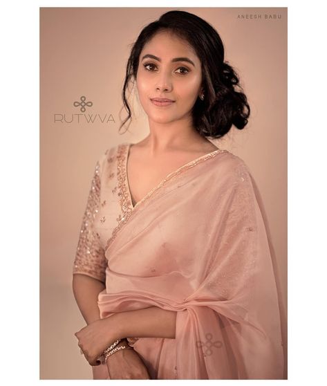 #Repost
///@rutwva_insta: 💮E.V.A.R.A💮
.
Pearl-peach organza saree with handembroidered borders and glass bead butta work on body.

This pastel saree look is tied together by pairing it with a pure rawsilk monotone blouse with heavily embellished sleeves and neckline with mini buttas all over blouse body.
.
Muse : @punya_elizabeth
Photography : @aneesh_traveller
Makeup&hair : @makeoverbykarthi
Outfit& styling : @rutwva_insta
Edit&retouch : @the.portrait.jn Peach Blouse Designs For Saree, Pastel Color Sarees Party Wear, Glass Sleeve Blouse Design, Pastel Pink Blouse Design, Peach Blouse Design, Pastel Saree For Farewell, Peach Saree Look, Blows Design, Pink Blouse Design