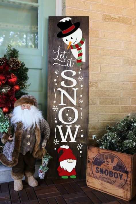 Your front porch will burst with holiday cheer with this charming �Let It Snow� sign! Featuring an adorable snowman and gnome, this festive wooden sign adds a playful, wintry touch. The bold white lettering against the dark wood makes it stand out beautifully, while its rustic design perfectly complements any outdoor holiday setup. Winter Signs Wooden, Christmas Signs Wood Front Porches, Gnome Christmas Decor, Let It Snow Sign, Christmas Crafts For Adults, Winter Signs, Ornament Display, Diy Snowman, Diy Christmas Decorations