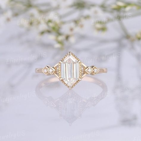 Vintage Hexagon Cut Moissanite Engagement Ring Women Moissanite Wedding Ring Solid Gold Art Deco Promise Wedding Ring Anniversary Gift Link to the Moonstone engagement ring: https://www.etsy.com/listing/1730441377 RING DETAILS METAL: available in 14k or 18k solid yellow gold, white gold, rose gold ( Please contact me directly for palladium or platinum.) ENGAGEMENT RING CENTER STONE: Moissanite SIZE: 5x9mm SHAPE: Hexagon cut ACCENT STONES: Moissanite SHAPE: Round shaped About 0.016ct Or side ston Starburst Cut Engagement Ring, Mossinate Engagement Ring, Hexagon Cut Engagement Ring, Single Diamond Engagement Ring, Engagement Rings Art Deco, Hexagon Engagement Ring, Art Deco Wedding Ring, Hexagon Ring, Hexagonal Ring