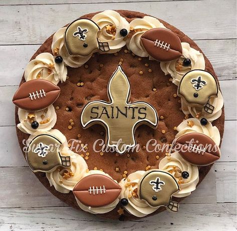 Saints football cookie, cookie cake! 🏈 . . . #saintsfootball #neworleanssaints #football #cookiecake #cookiecookiecake #buttercream… Football Cookie Cake Designs, Superbowl Cookie Cake, Football Cookie Cake, Cookie Cake Football Designs, Football Stadium Cookies Decorated, Football Season Decorated Cookies, Cookie Displays, Creative Deserts, Cupcake Business