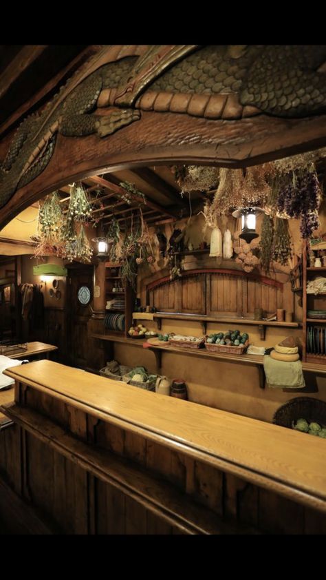 Fantasy Store Interior, Green Dragon Tavern, Lotr Decor Interiors, Lotr Room, Hobbit Kitchen, Tavern Kitchen, Lotr Decor, Fantasy Bar, Fantasy Lighting