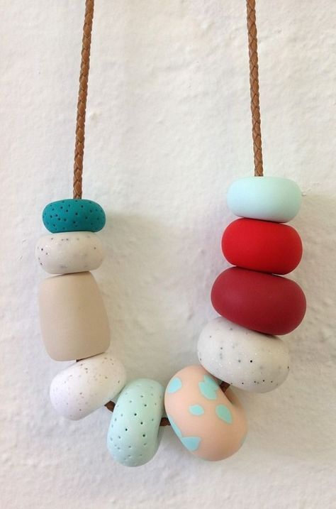 Fimo, which you can buy from most craft shops and online, is a brilliant craft material. Simply sculpt some shapes from the clay (leaving a hole to thread a chain through) and stick it in the oven to create a winning necklace for your mate. [Photo: Pinterest] Bead Looming, Fimo Beads, Fimo Jewelry, Polymer Beads, Polymer Clay Necklace, Fimo Clay, Clay Design, Clay Necklace, Polymer Clay Projects