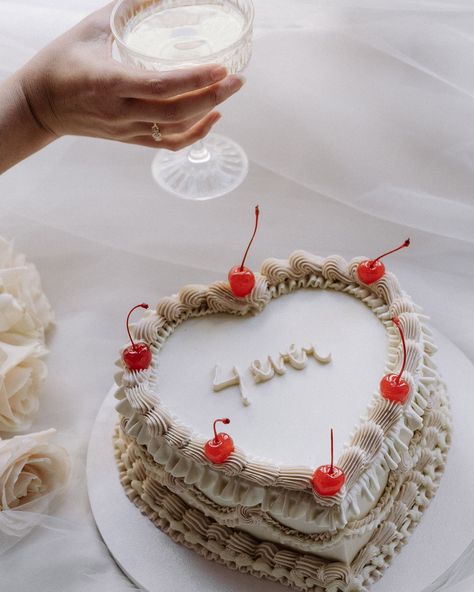 This whimsical cake is a perfect reflection of the timeless beauty of romance. With delicate piping and vibrant cherries adding a playful touch, this heart-shaped cake is a celebration in itself. Ideal for capturing those sweet moments of a wedding day or any special occasion. Paired with a glass of bubbly, it brings a charming, vintage feel that’s both nostalgic and elegant. „4ever“ indeed — because love stories like this deserve an unforgettable treat. Featured in @togetherjournal H... Heart Shaped Wedding Cakes, Whimsical Cake, Wedding Pie, Classic Wedding Cake, Elopement Styling, Unique Wedding Cakes, Wedding Cakes Vintage, Sweet Moments, White Wedding Cake