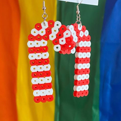 Candy Cane earrings! Cute simple candy canes to show your love for the peppermint treat! I personally stick them in my hot cocoa every winter season - YUMMY! Luckily, these earrings match everything; the same way peppermint is a great addition to most things all winter! Perfect for anything this Christmas season may throw at you Dimensions: Full (w/ hooks included) Length: 3 in Width: 1.5 in Height: n/a (flat) Weight: (1) Dangle style ear wire is hypoallergenic sterling silver for a minimalist c Christmas Ornament Perler Beads, Snowflake Perler Bead Patterns, Christmas Perler Bead Ideas, Perler Beads Christmas, Hammer Beads, Perler Christmas, Sellable Crafts, Ironing Beads, Candy Cane Earrings