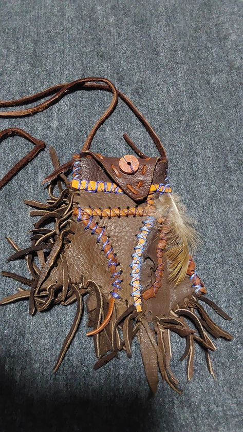 One of a kind abstact art medicine pouch made out of dark brown deer leather with redish brown leather and blue thread accents with a round stone bead. Medicine Bags, Medicine Pouch, North Idaho, Brown Deer, Ren Fest, Pouch Purse, Fringe Purse, Medicine Bag, Deer Skin