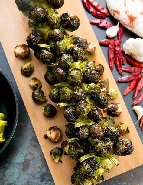 Brussels sprouts are brushed with spicy garlic oil and roasted directly on the stalk for a fun presentation. It is also an easy Thanksgiving side dish. I picked up Brussel Spouts Stalks last weekend at Trader Joe’s. It’s become an annual tradition and I love finding new ways to cook them. Cooking the Brussels Sprouts … Rainbow Chard Recipes, Swiss Chard Recipes, Thanksgiving Side Dishes Easy, Chard Recipes, Rainbow Chard, Roasted Brussels Sprouts, Cauliflower Crust, Roasted Brussel Sprouts, Roast Recipes