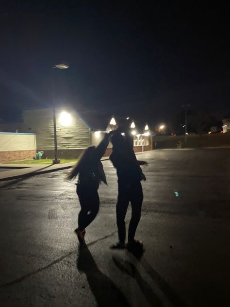 Dancing under a streetlight in a parking lot Dancing Under A Streetlight Aesthetic, Best Friends Parking Lot Pictures, Couple Under Street Light, Couple In Park At Night, Slow Dance In A Parking Lot, Parking Lots At Night, Dancing Night Aesthetic, Dark Parking Lot Photoshoot, Couple Parking Lot Pictures