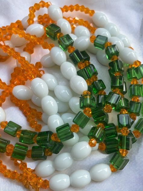 Double Strand Elastic Waist Bead "Daoukro" – a vibrant creation meticulously crafted with lively orange glass crystal seed beads, elegantly adorned with accents of pure white and refreshing green crystal glass seed beads. This double-strand elastic waist bead not only embodies the zest of citrus blooms but also radiates a harmonious charm, offering a comfortable and adjustable fit that transcends beauty and symbolism. 🍊 Orange Glass Crystal Seed Beads - Citrus Zest: Daoukro is adorned with a burst of lively orange glass crystal seed beads, capturing the essence of citrus zest. The vibrant hue symbolizes energy and enthusiasm, adding a touch of lively brilliance to your ensemble. 🌼 White and Green Crystal Glass Seed Bead Accents - Fresh Elegance: Intertwined among the orange beads are del Waist Beads African, Mala Beads Bracelet, Bracelets Patterns, Strong Hand, Creation Crafts, Diy Bracelets Patterns, Waist Beads, Beads Jewellery, Green Crystal